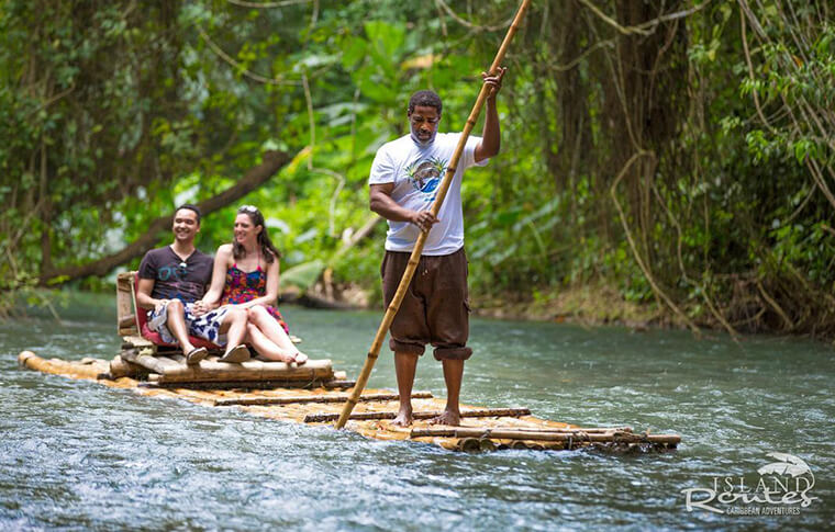 man on bamboo raft with couple
